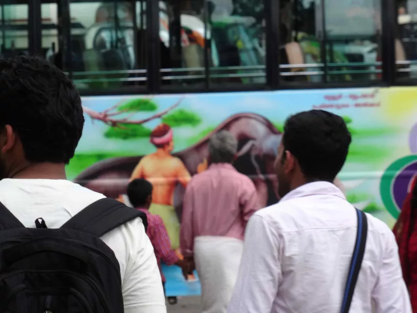 Indian men infront of an painted bus