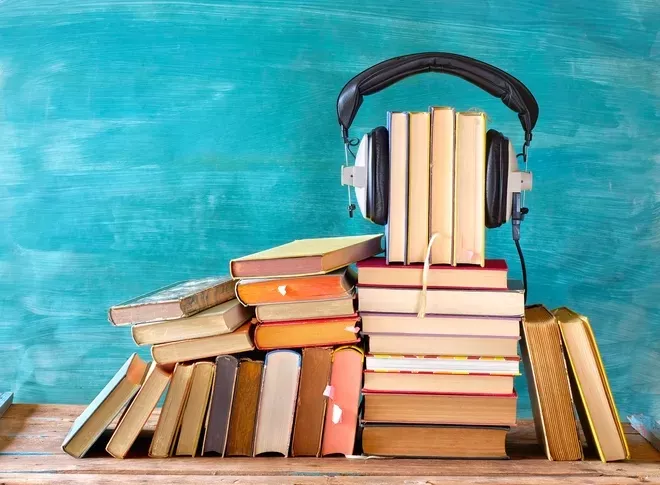 A pile of books with headphones 